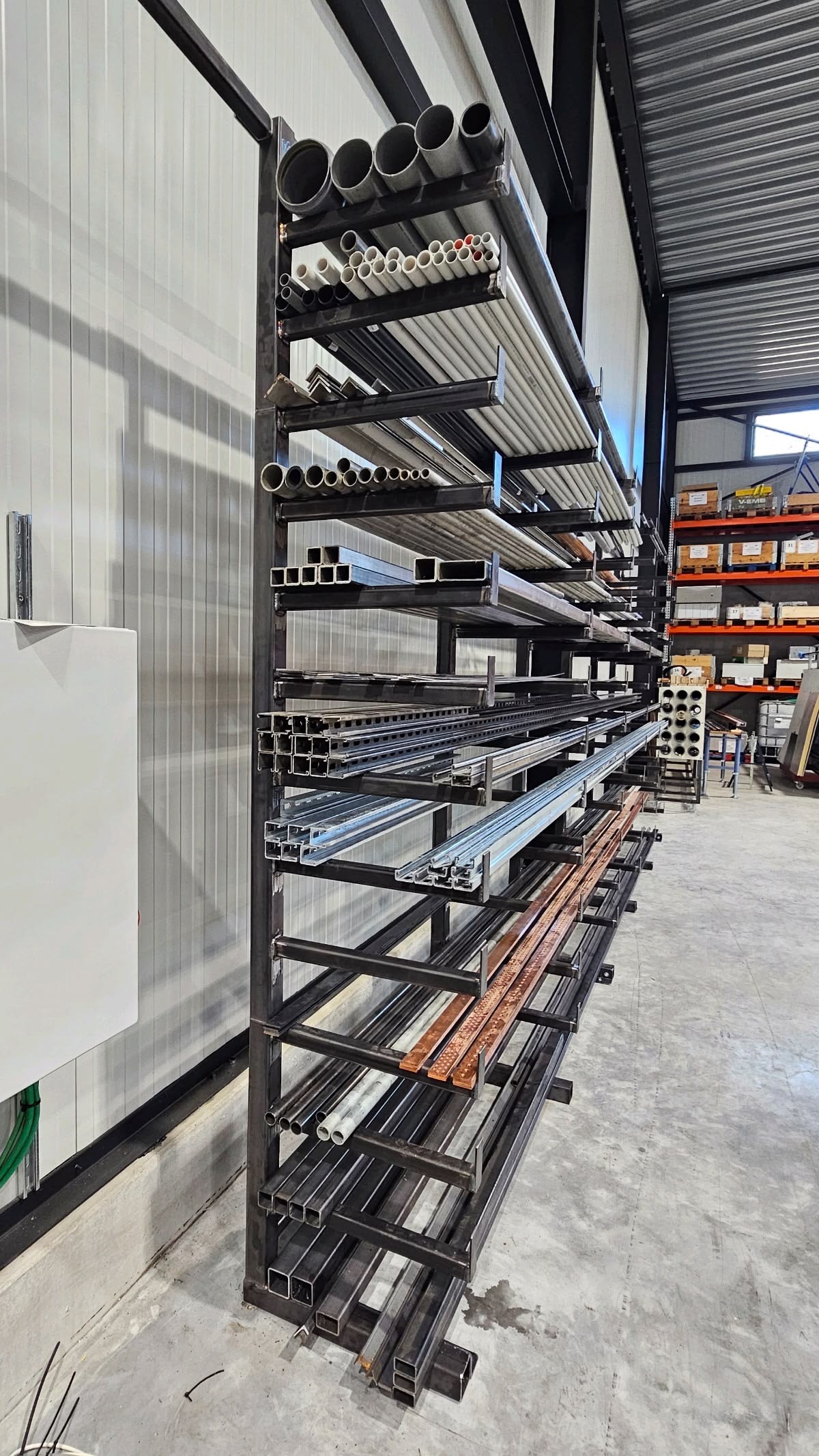 Rayonnage métallique avec profilés et tubes dans un atelier